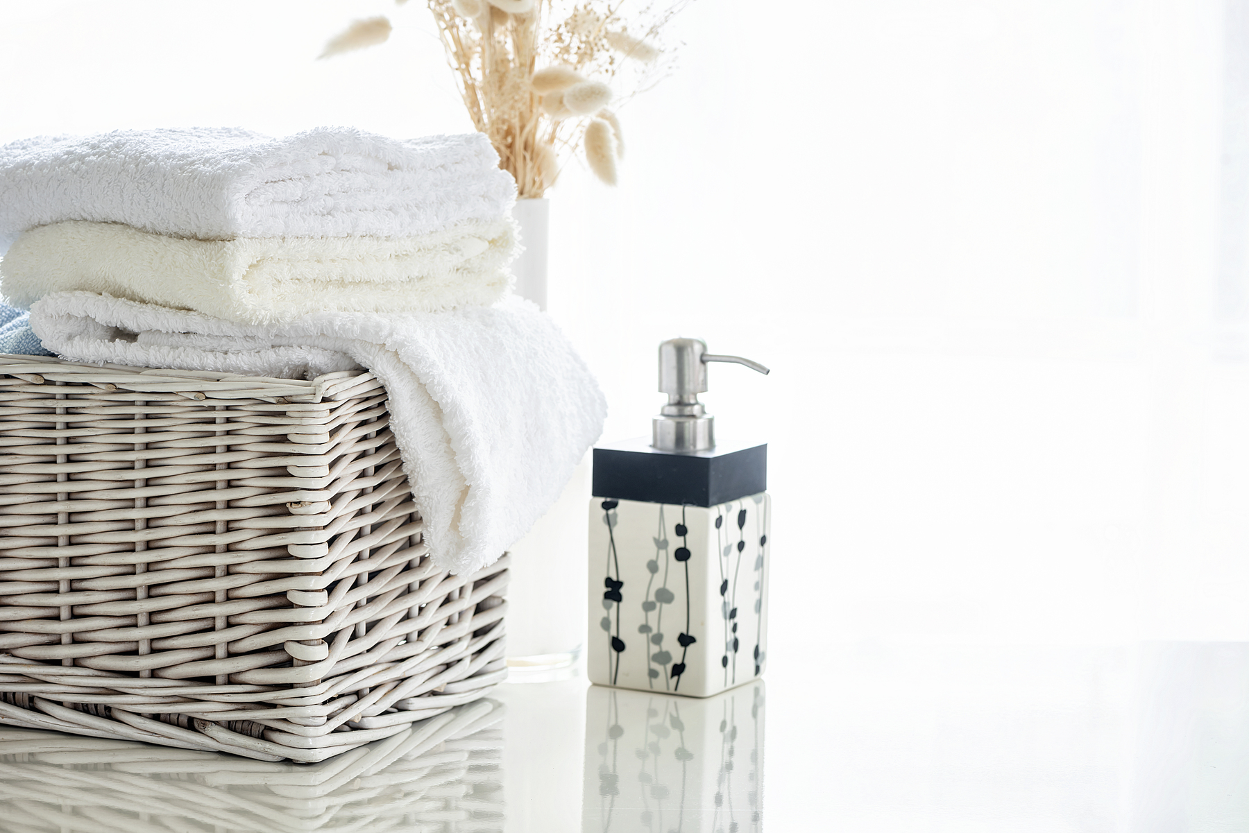 white-towels-rattan-basket-white-table-with-bright-room-background.jpg